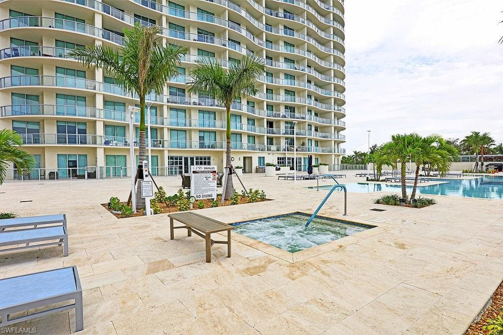 Expansive outdoor amenity deck featuring a bubbling spa and multiple pools