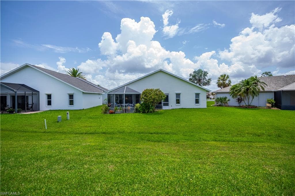 Expansive green lawn bordering the rear of the property