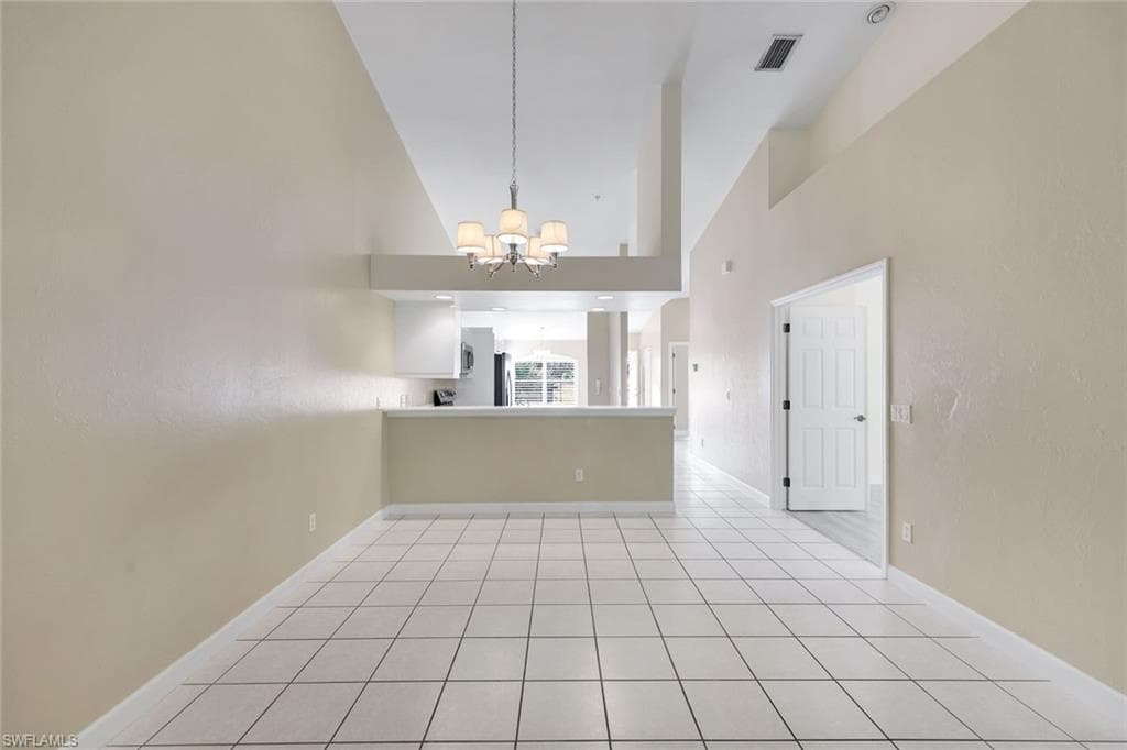 DINING / KITCHEN AREA WITH 17' VAULTED CEILING WHICH GIVES A SENSE OF MORE SPACE