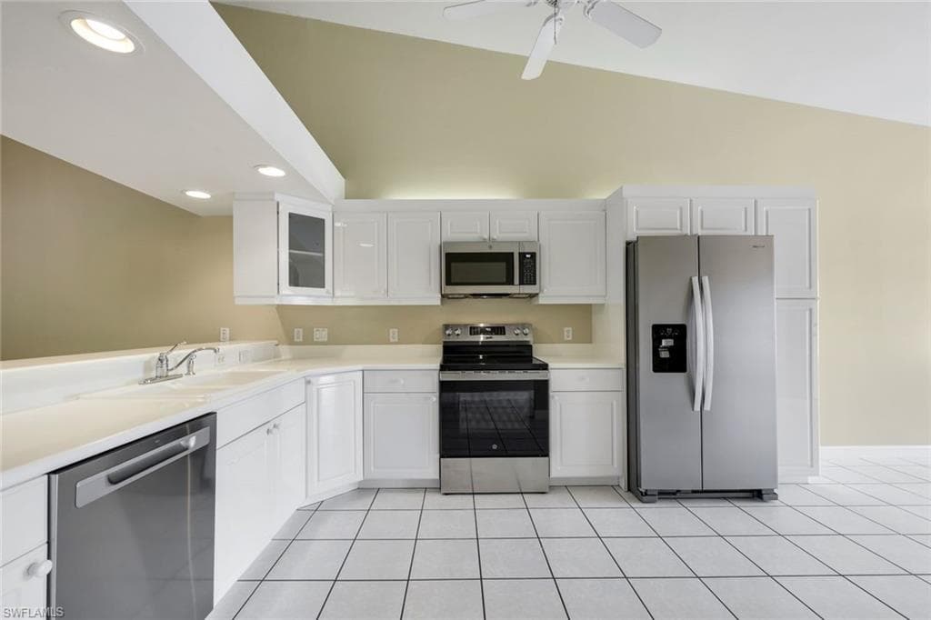 WHITE CORIAN COUNTERS AND TILE FLOORING