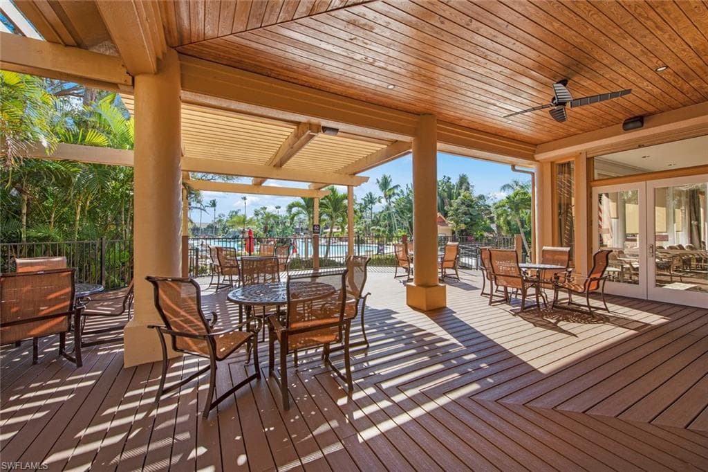 DECK AREA AT THE REAR OF THE CLUBHOUSE LEADING TO THE POOL