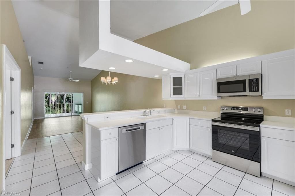 KITCHEN WITH WHITE RAISED PROFILE CABINETRY