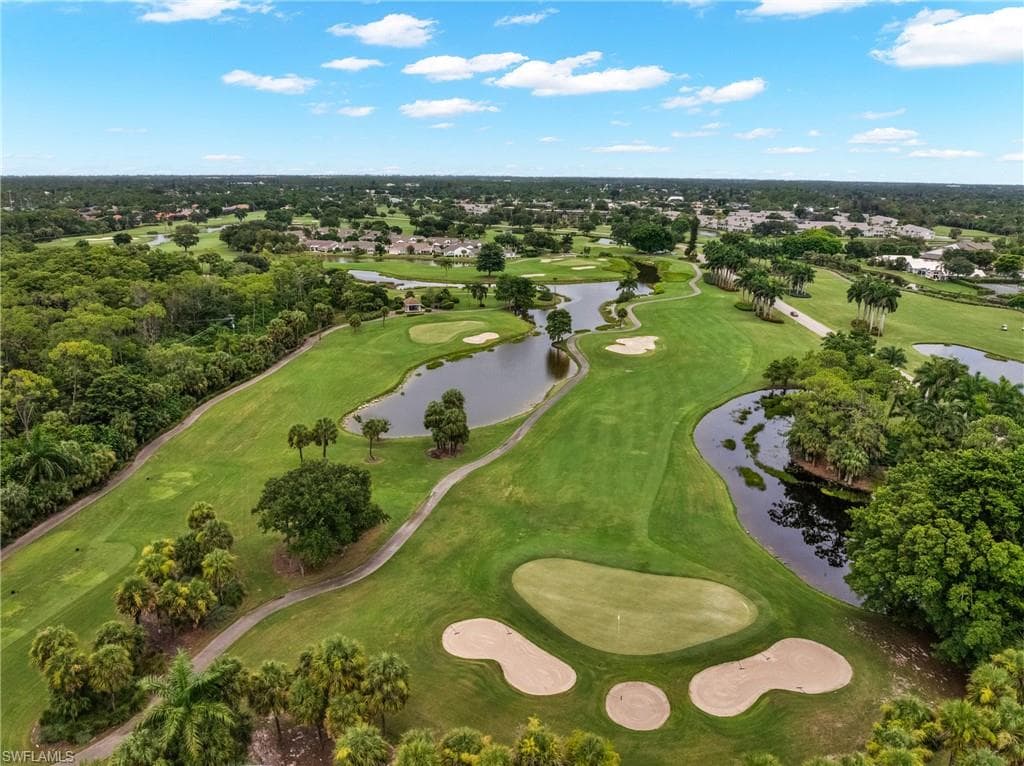 Expansive golf course featuring multiple greens, sand traps, and water features