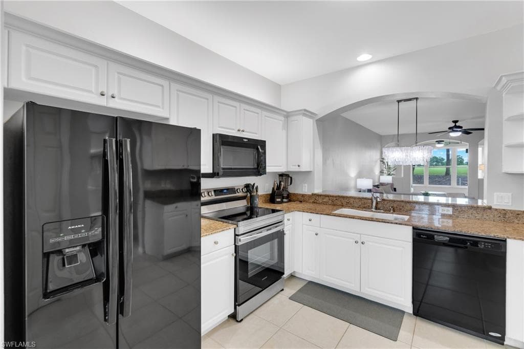 Kitchen featuring white cabinetry, granite countertops, and black appliances