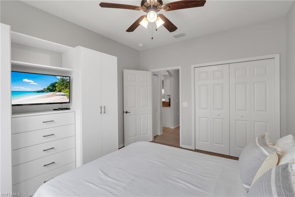 Built-in storage solutions featuring a white dresser and wardrobe cabinetry