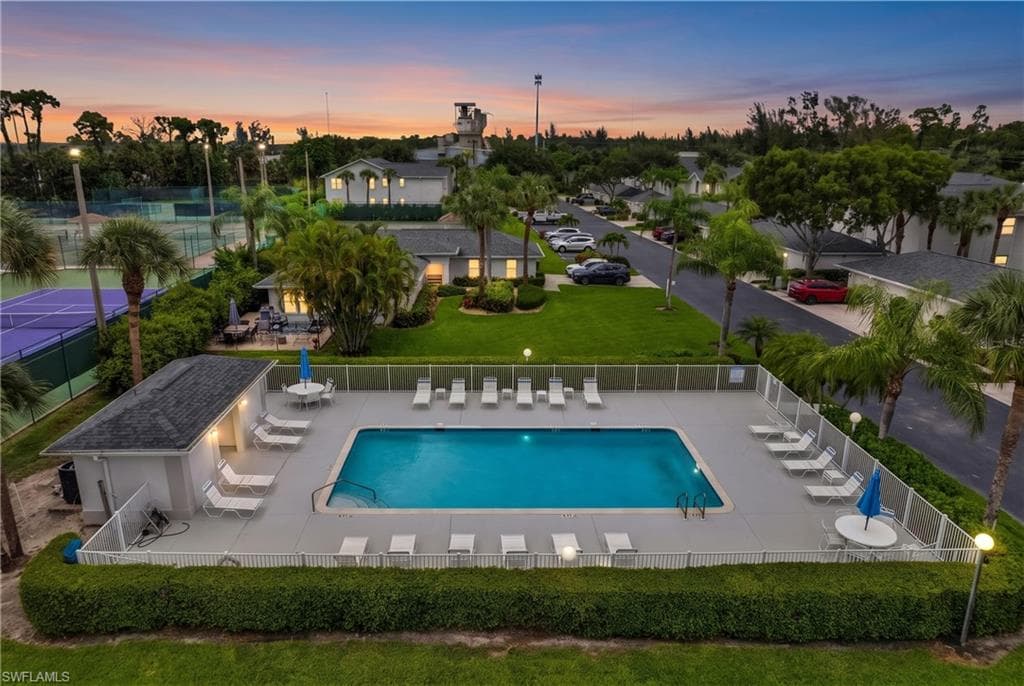 Outdoor swimming pool with surrounding lounge chairs and a dedicated pool house