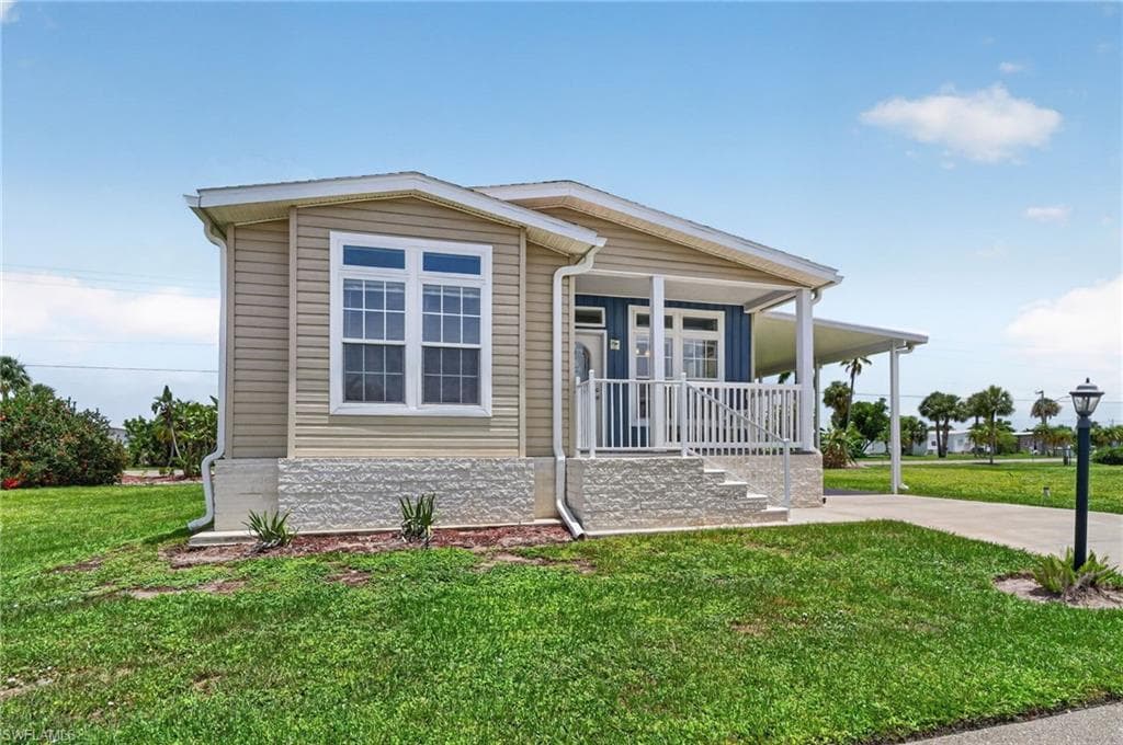 Single-story residence featuring light beige siding and a covered front porch with white railings