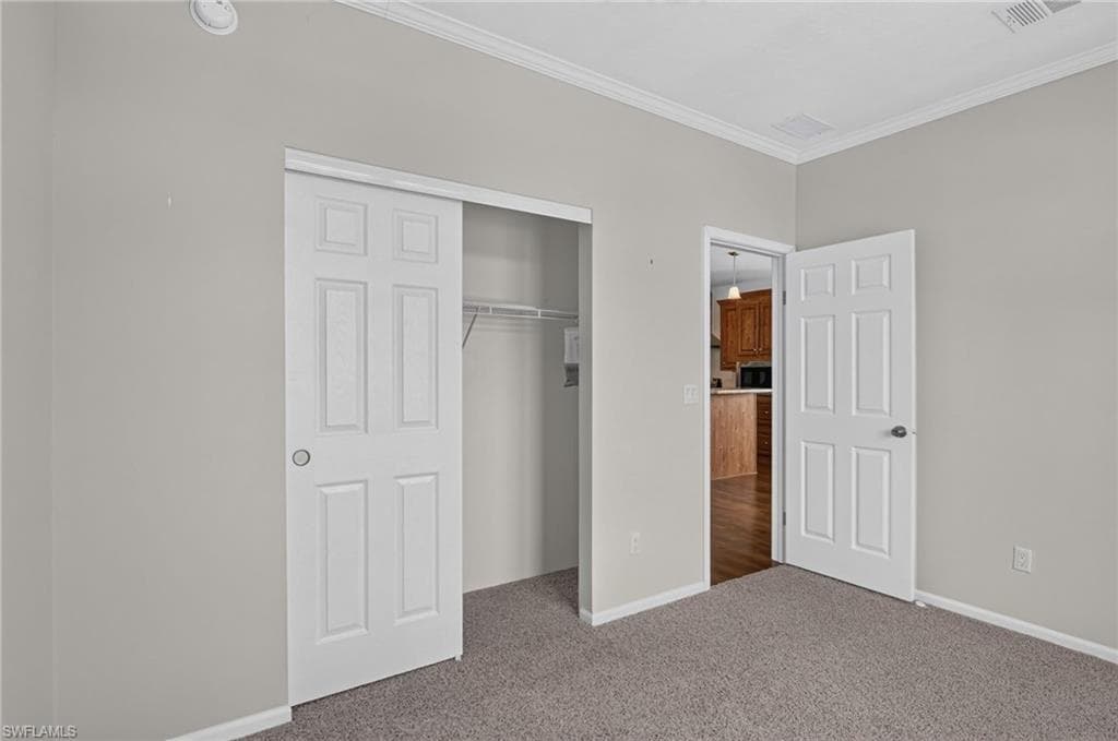 Bedroom 1, Neutral-toned wall paint and grey carpeting create a versatile interior palette