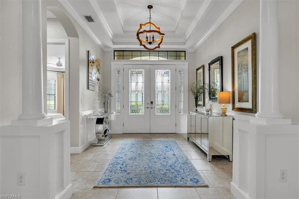 Grand entry with arches, columns, tray ceilings and crown molding