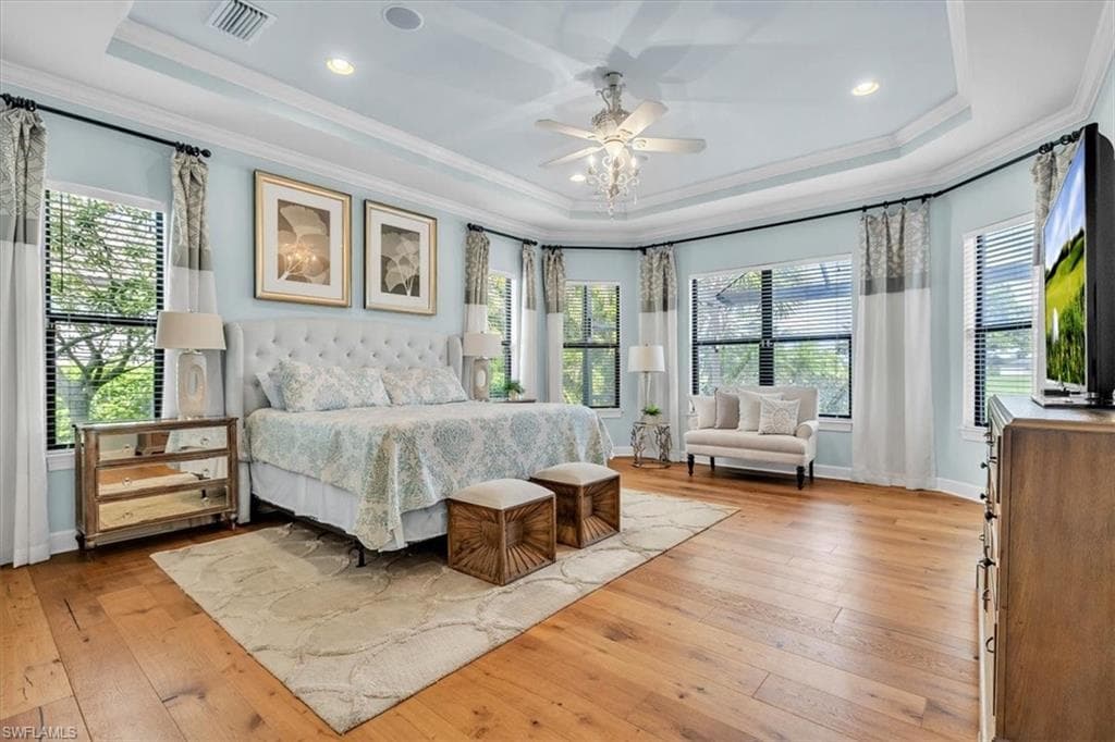 -featuring a sitting area, tray ceiling, and custom drapery