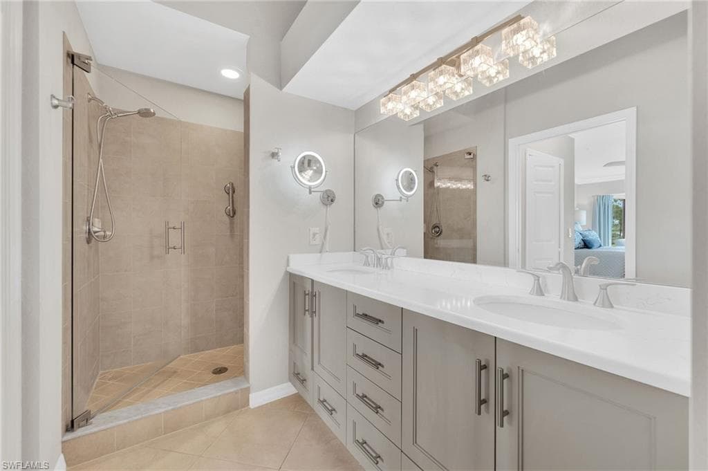 Gorgeous Primary Bath with frameless glass shower door, double sinks, new Lighting and updated vanity