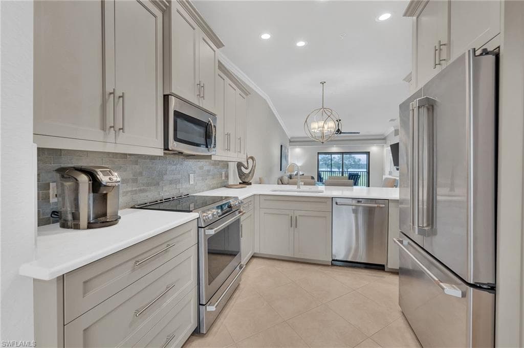 Newer upscale appliances, backsplash, Quartz counters, refaced cabinets and designer lighting
