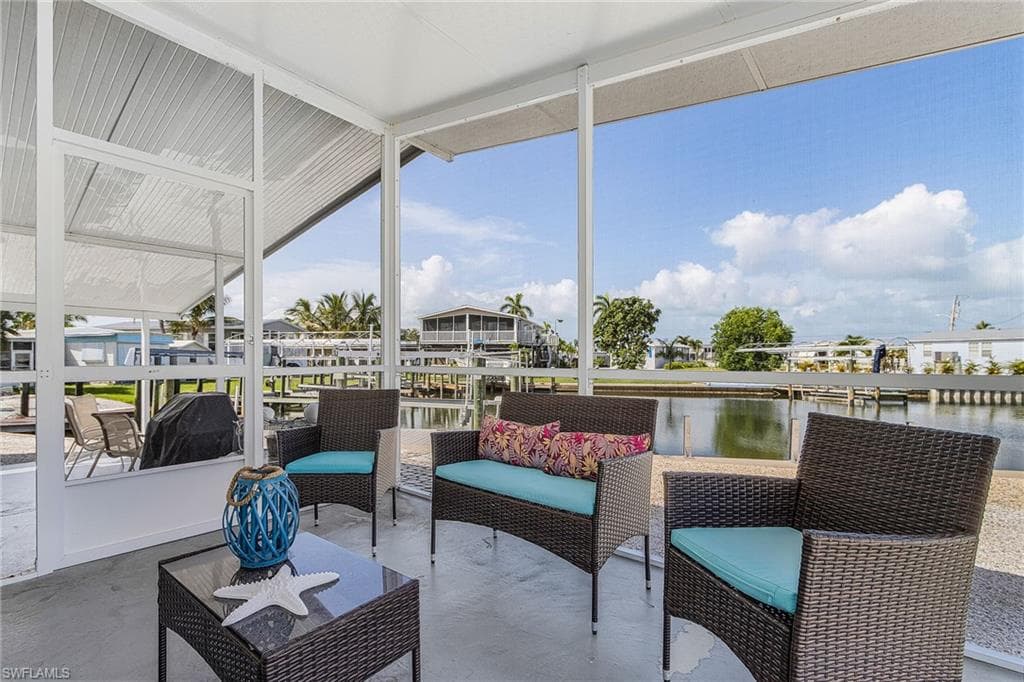 Screened patio with a concrete floor, aluminum framing, and water frontage