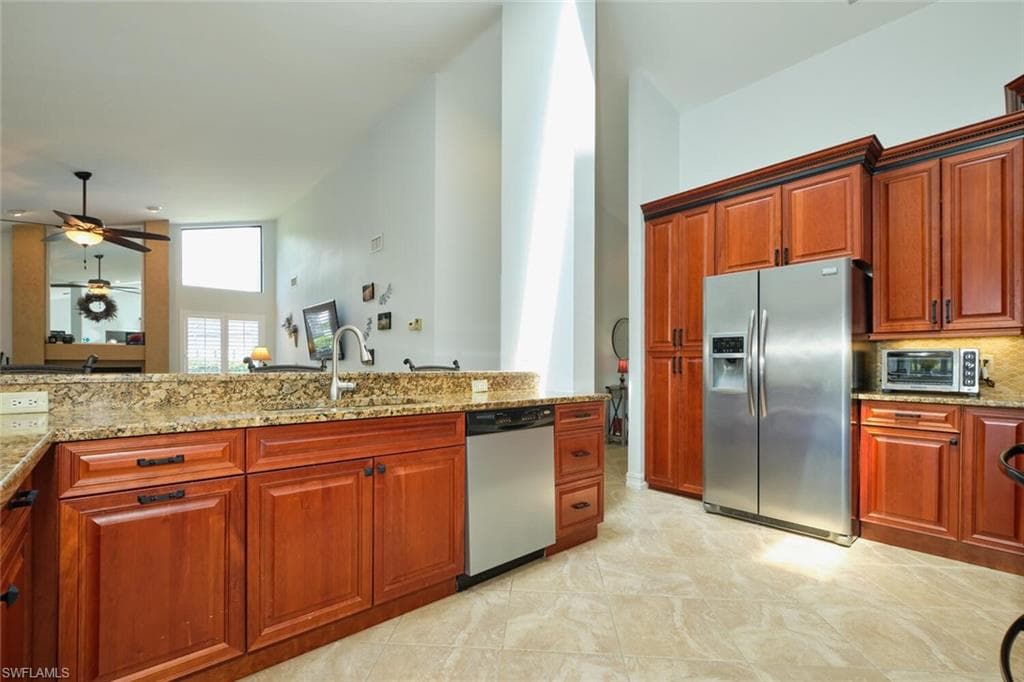 Kitchen featuring light granite counters, stainless steel appliances, lots of cabinet and counter space.