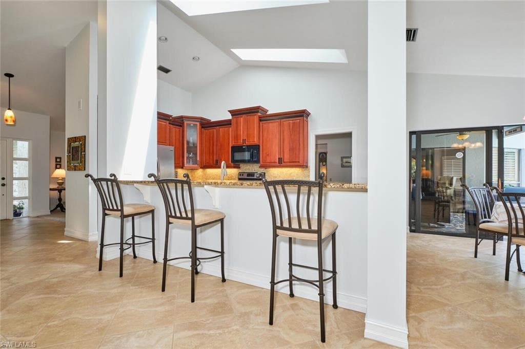 Kitchen features a large breakfast bar area.