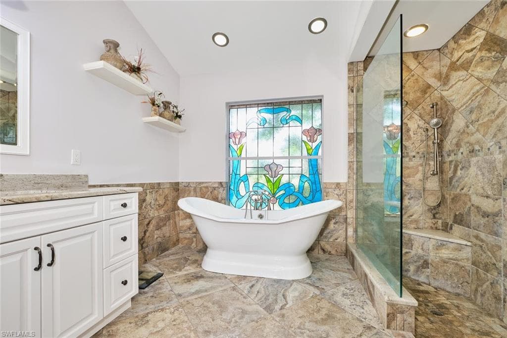 Owner's bath has a large walk-in tiled shower with bench seat.