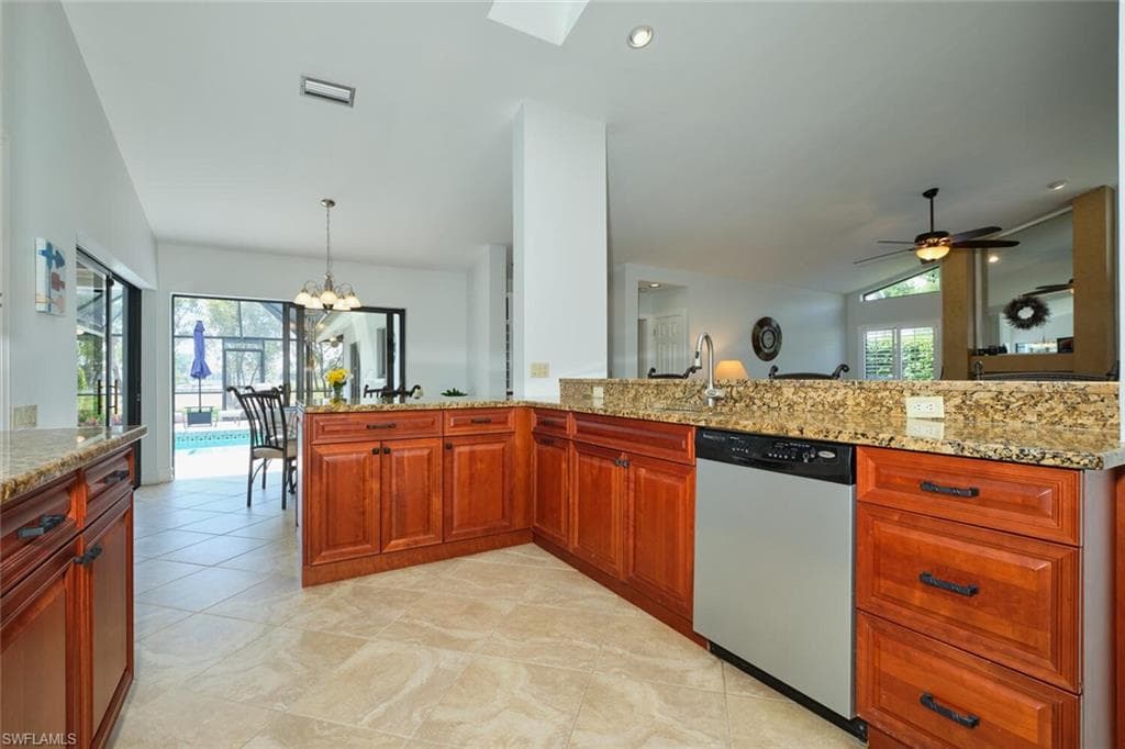 Large kitchen is open to the great room and has high, vaulted ceilings.