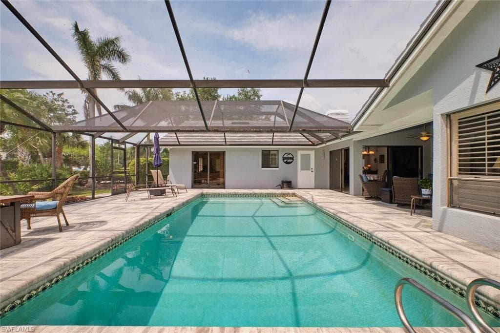 Outdoor pool featuring a lanai and a patio area