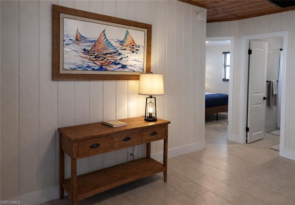 Vertical shiplap paneling complements the wood-finish ceiling and flooring