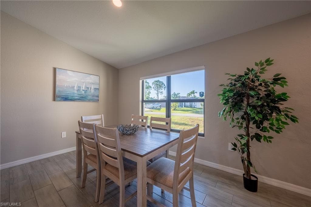 Dining area featuring wood-finish flooring and a large window