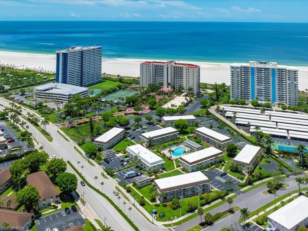 Aerial overview of a coastal community featuring multiple residential buildings
