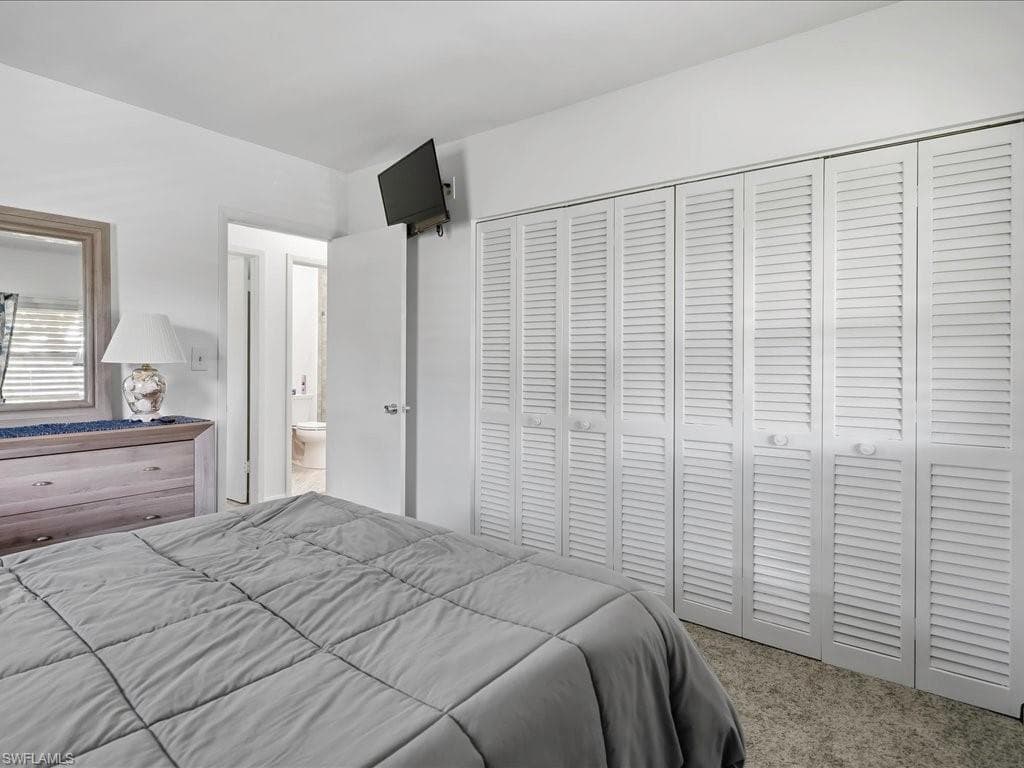 Wall-to-wall louvered closet doors spanning the room's width