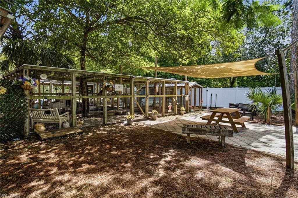 The custom chicken coop brings authentic farm to table living to this exceptional in town. Naples acreage. Enjoy a rare lifestyle where luxury meets country charm.