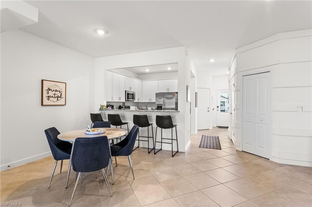 The adjoining living and dining areas are open, airy, and perfect for both relaxing and entertaining