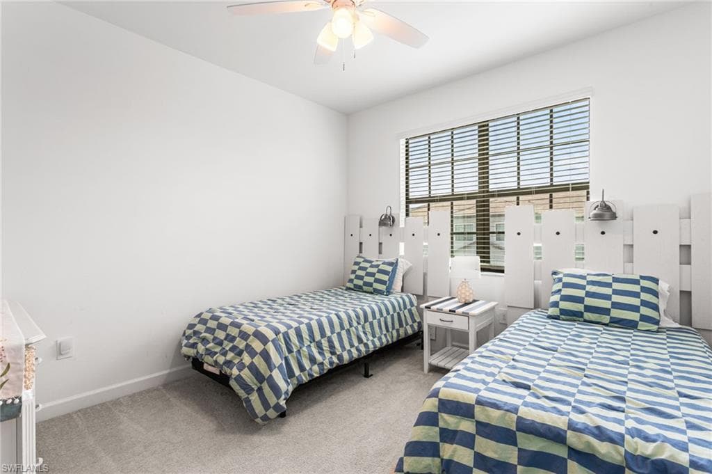 Two generous guest bedrooms at the front of the home are thoughtfully decorated with beach-themed accents, creating a welcoming coastal vibe