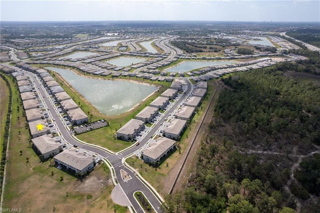 Aerial view showcasing the home’s prime location within the beautifully planned Timber Creek community, surrounded by scenic lakes and green spaces and located outside a designated flood zone