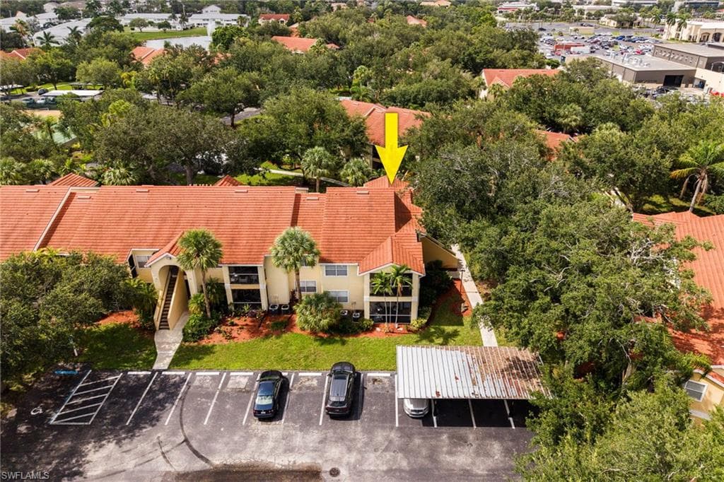 Multi-story residential building featuring a tile roof and stucco exterior