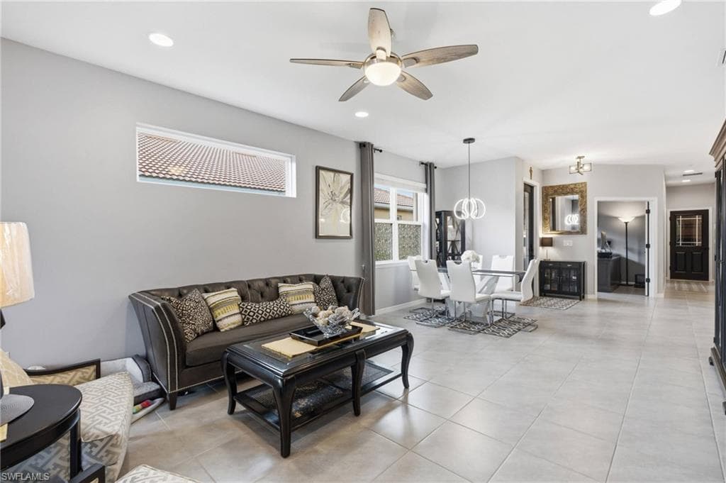 Open-concept living area with light gray wall tones and recessed lighting