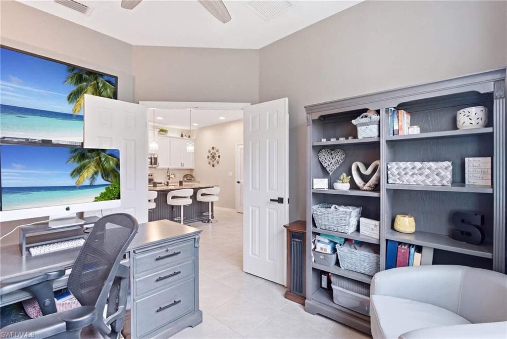Home office featuring neutral wall tones and tile flooring
