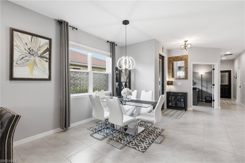 Dining area featuring light-toned tile flooring, light gray wall paint, and a rectangular window with frosted lower panes