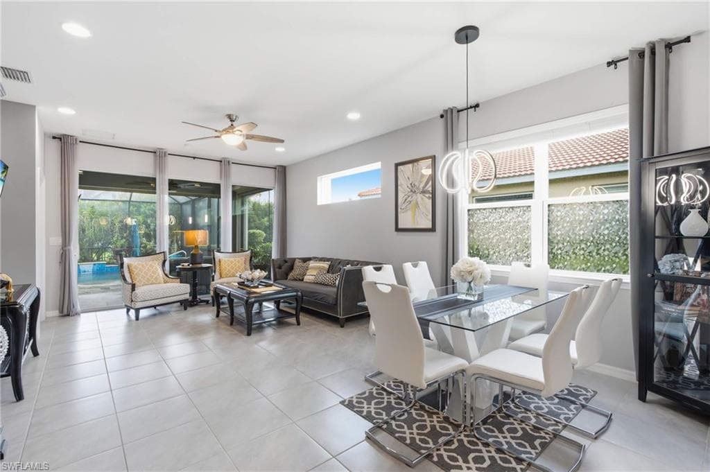 Open-concept living and dining area featuring light-toned tile flooring throughout