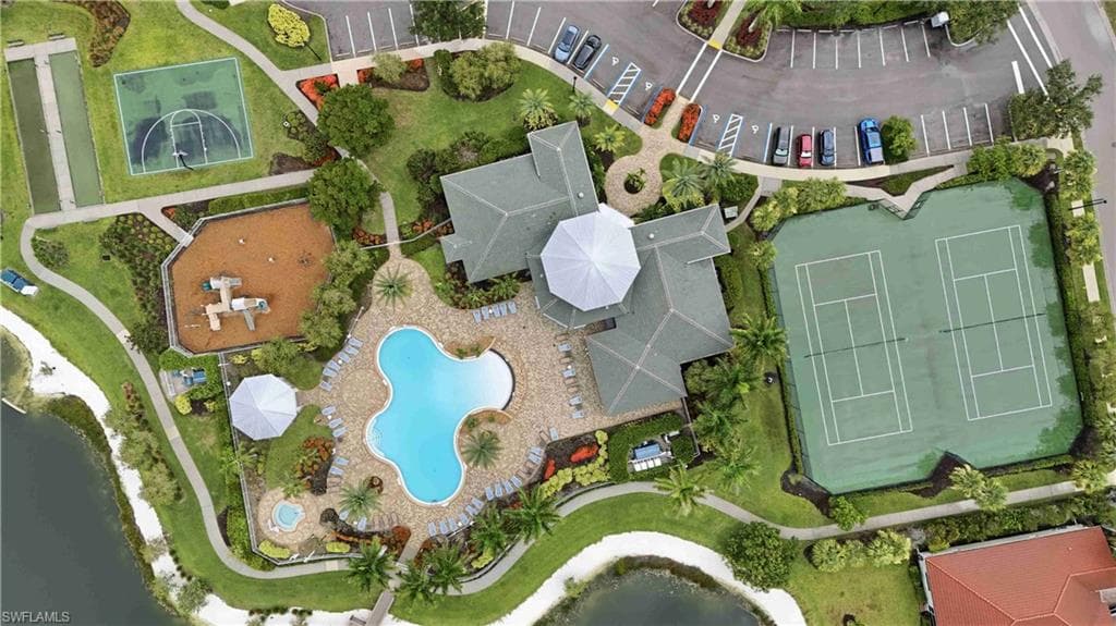 Community clubhouse with a resort-style pool, spa, and surrounding lounge areas