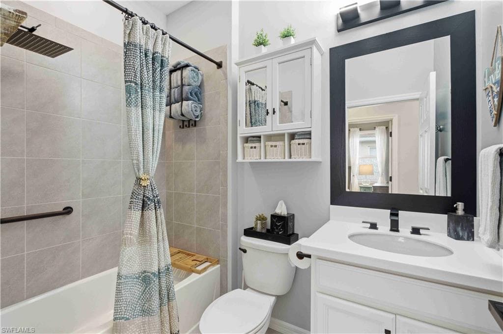 Bathroom featuring a white vanity with a rectangular sink and matte black faucet, a framed mirror, and a white medicine cabinet with open shelving
