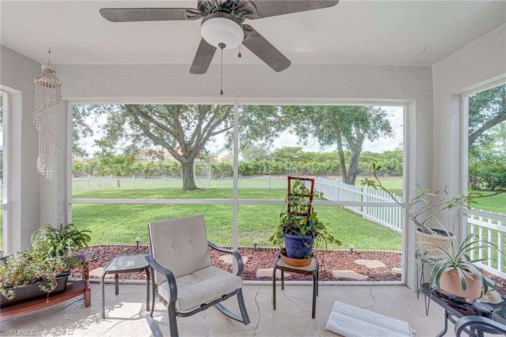 Screened in lanai overlooking fenced backyard.