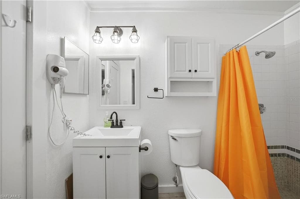 Bathroom with a white vanity and integrated sink, black faucet, and framed mirror