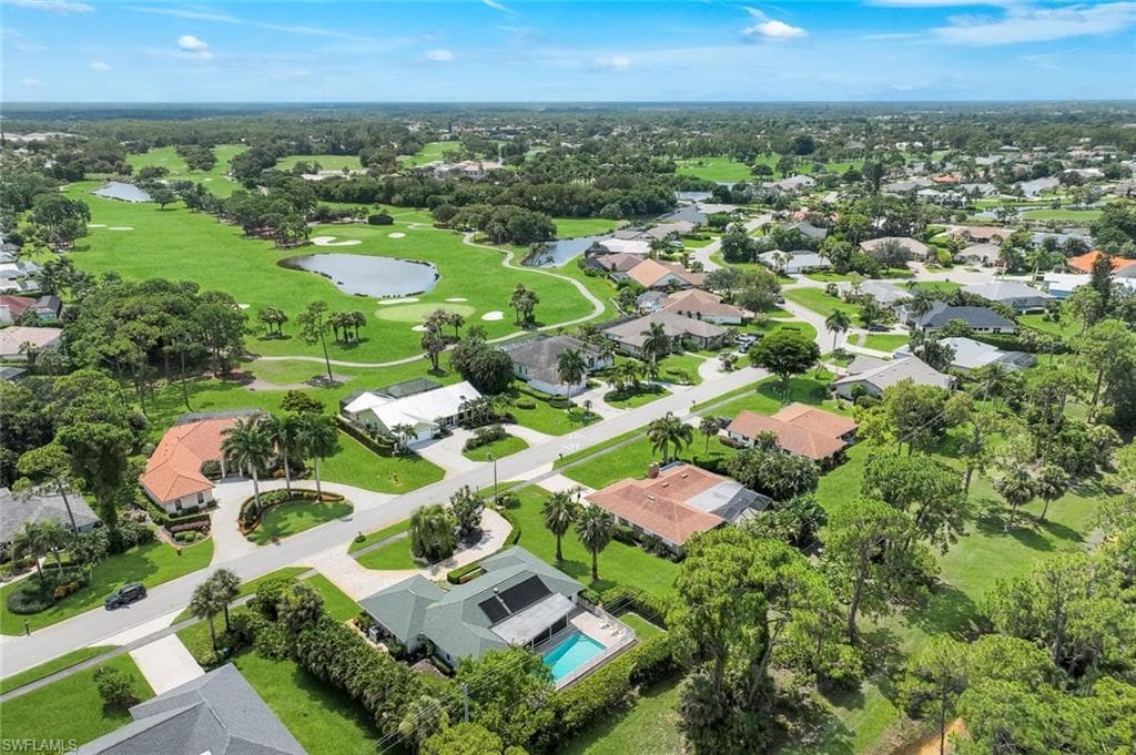 Aerial view of the home. Solar panels heat the pool.