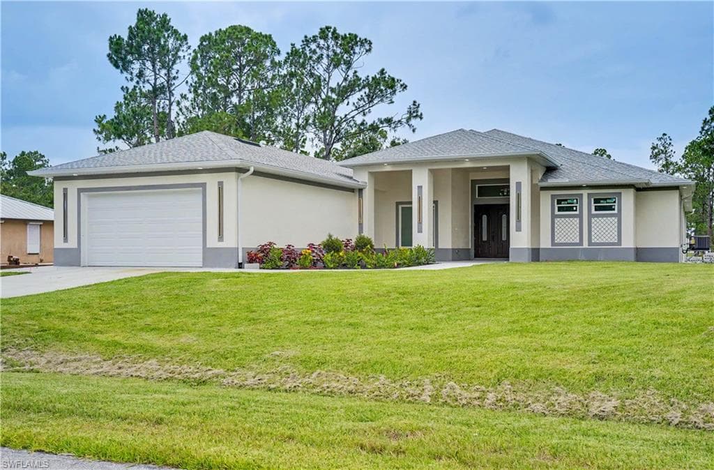 Contemporary stucco exterior with a gray trim, featuring a dark wood double-door entry and an attached two-car garage