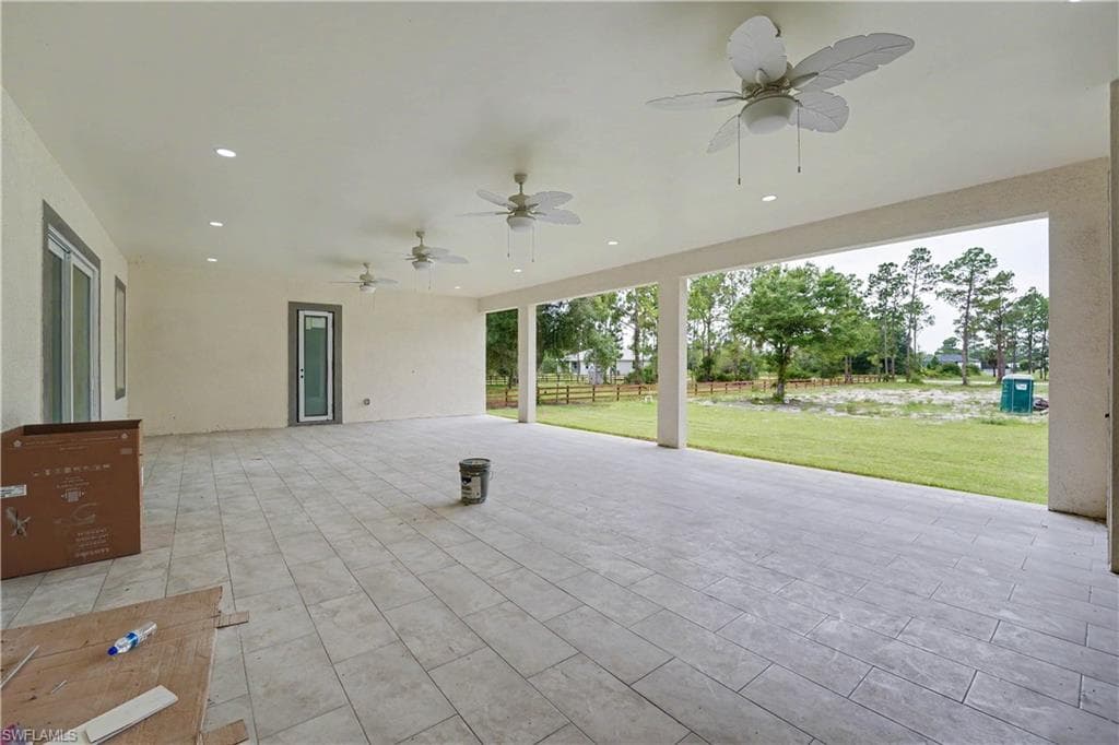 Expansive covered patio featuring large format tile flooring, recessed lighting, and multiple ceiling fans