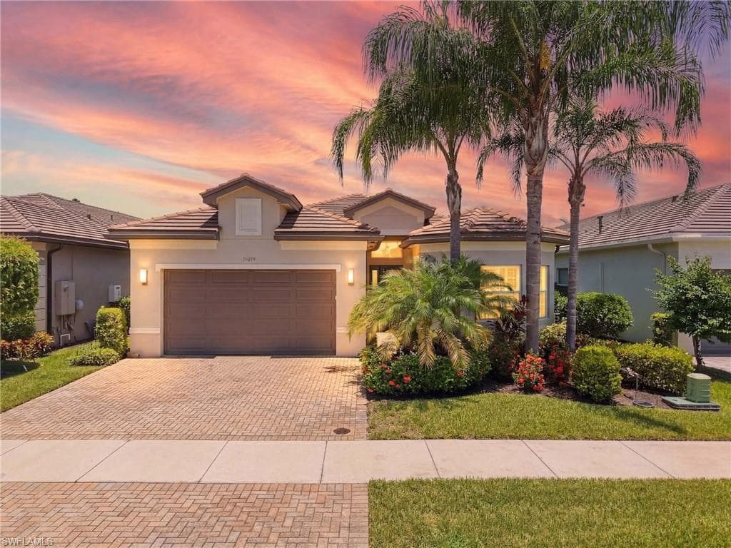 Welcome Home! Chandon Floorplan featuring a tile roof, a 2 car garage and a paver driveway!