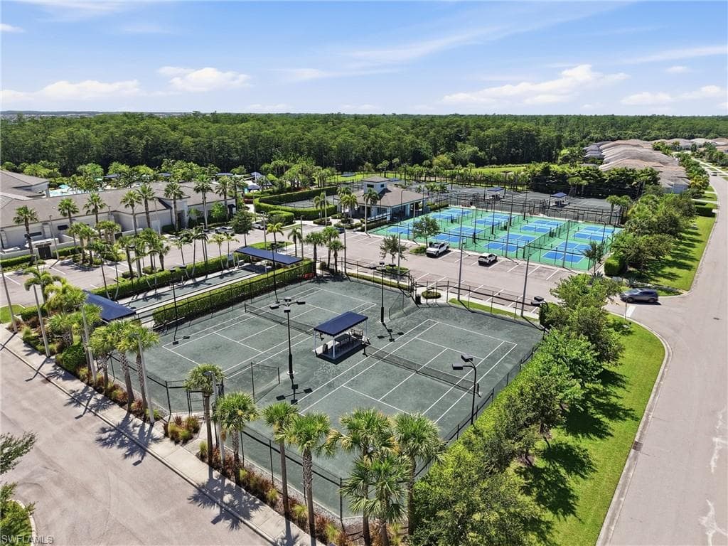 Aerial perspective showcasing multiple tennis courts, pickleball courts and bocce.