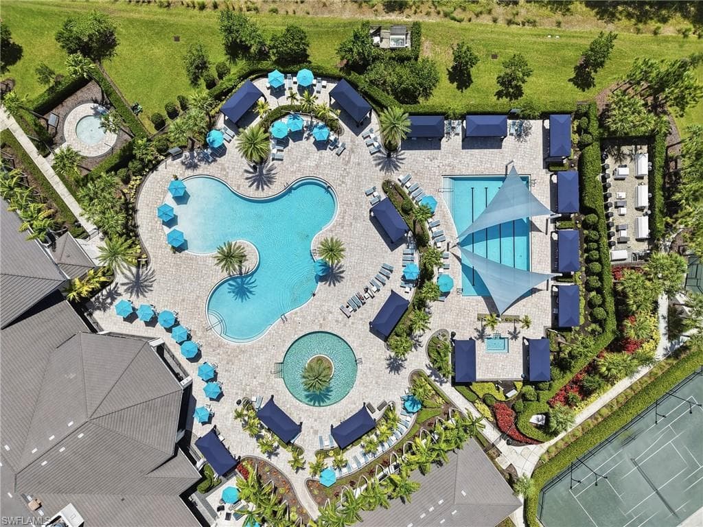 Expansive outdoor amenity area featuring two swimming pools, a spa and tennis courts