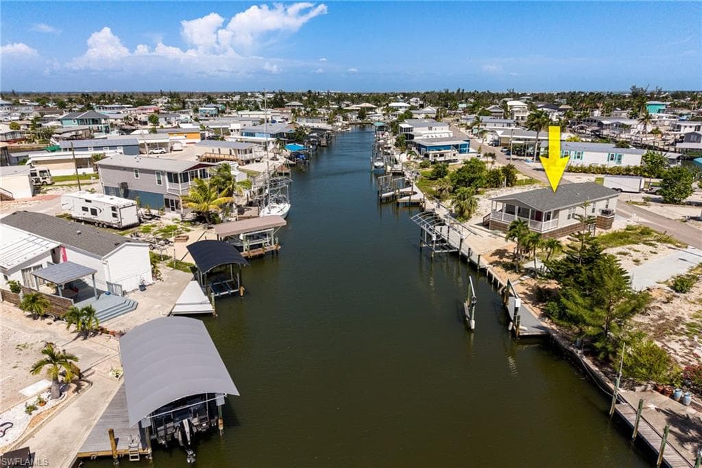 Waterfront property featuring direct gulf access, a private boat dock and lift, and a large, covered porch for entertaining.