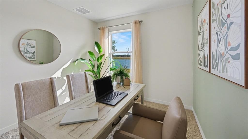 Dedicated room featuring a window with water scenery, light-toned walls, and carpeting
