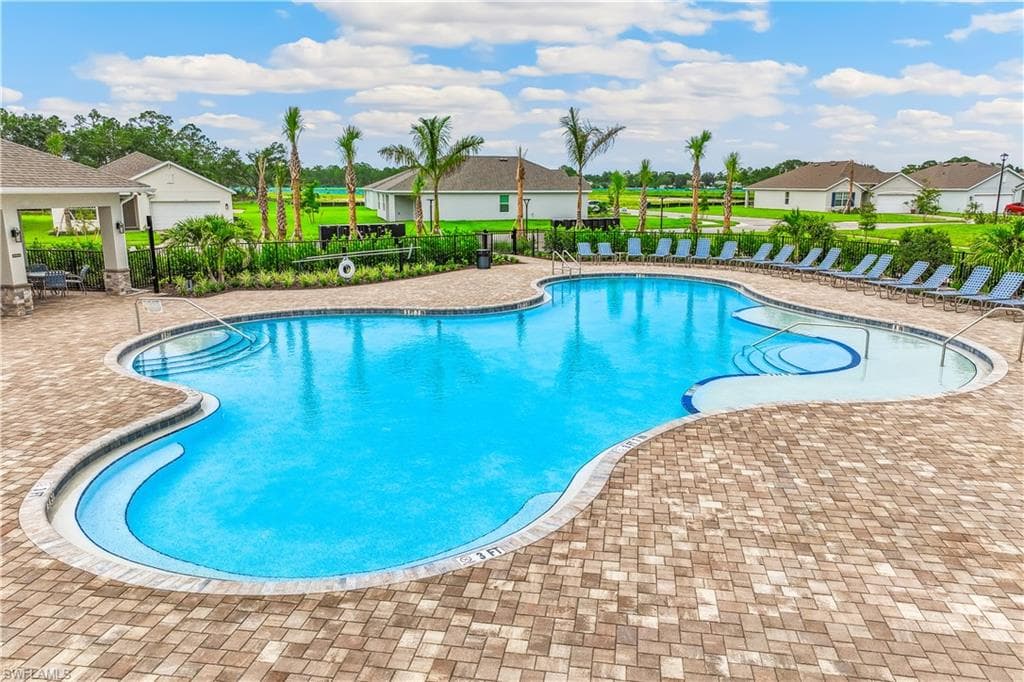 Expansive resort-style swimming pool featuring varied depths and integrated steps