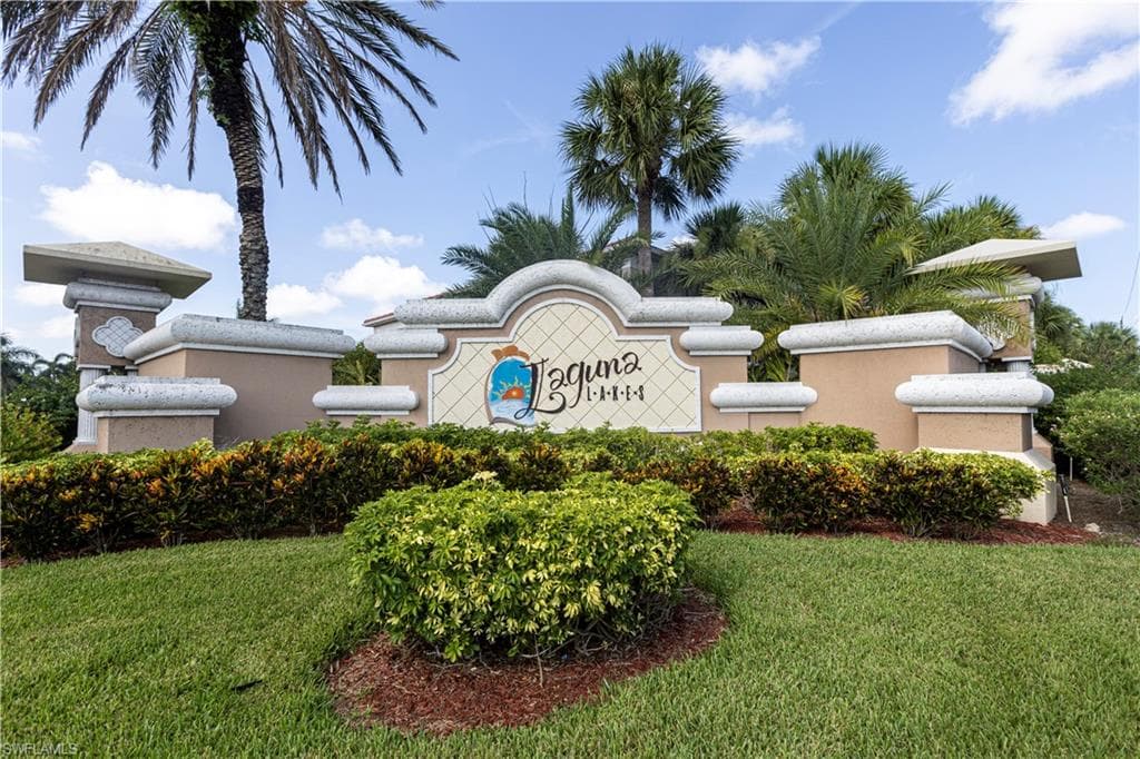 Community entrance sign featuring a decorative stucco finish and integrated lettering