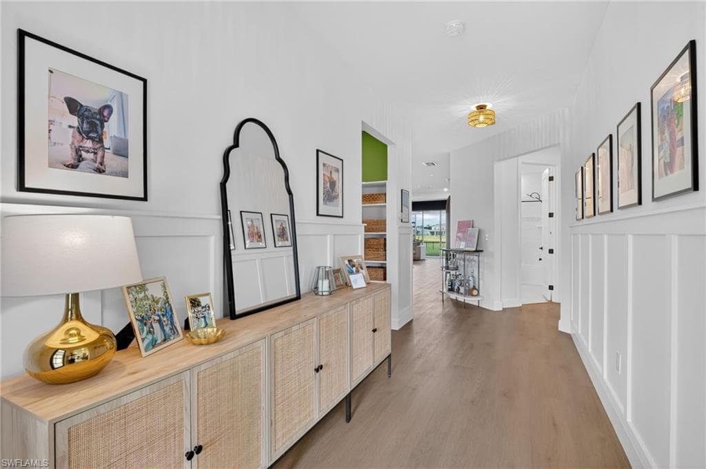 Entryway featuring board and batten wainscoting and wood-finish flooring